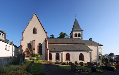 Gothic village church with transept gable and cemetery in Dockweiler, Eifel region in Germany