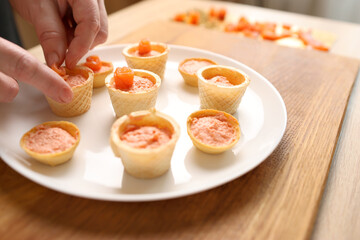 Waffle baskets with pate add salmon. Preparation of fish canapés`
