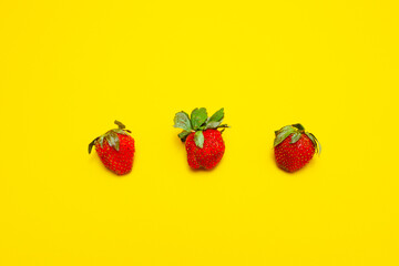 photo of strawberries isolated on yellow background