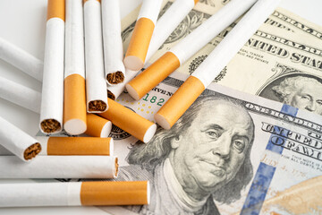 Cigarette on US dollar banknotes, cost, trading, marketing and production, No smoking concept.