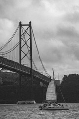 lisbon bridge with boat in vintage black and white