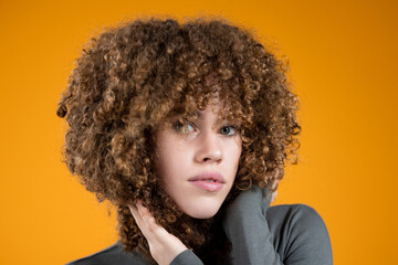 beautiful curly girl on yellow background