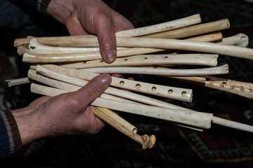 A wind instrument made of eagle wing bones in the hands of a man. Its Turkish name is "Cıgırtma". © TAMER YILMAZ