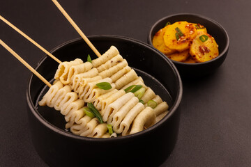 Eomuk Guk or Odeng Guk is Korean Fish Cake Skewer in Korean Soup, Served With Kimchi.  Korean Street Food Style.