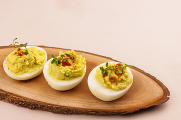 Deviled Eggs with Avocado, Garnish with Paprika Powder and Thyme.