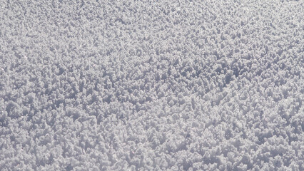 Snow textures after fresh snowfall, forming ice crystals on the ground and beautifull untouched snow cover.