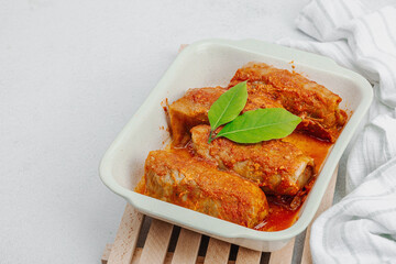 Cabbage rolls stuffed with rice and meat stewed in tomato sauce. Traditional dish, ready-to-eat food