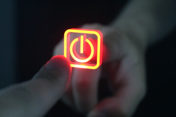 One finger pressing red sensor power button on a glass. Concept of networking or network hardware. Man presses the start button. Finger touches the power button icon. ON - OFF concept of something