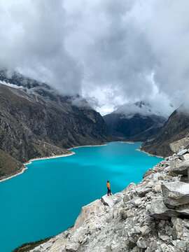 Huaraz, Peru. View of Laguna Par&oacute;n (Paron Lake) with moutains in the background. Laguna Paron in Cordillera Blanca near Huaraz in Peru.  In the distance stands one tiny person.