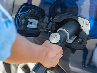 Refueling the car with hydrogen at a hydrogen fuel station