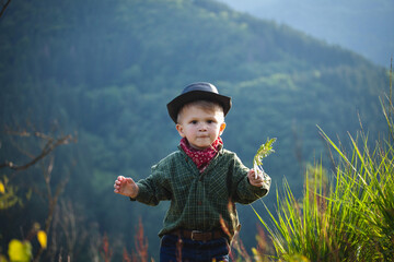 Cute Little Boy with Hat and Bandana in Beautiful Mountains - 743834811