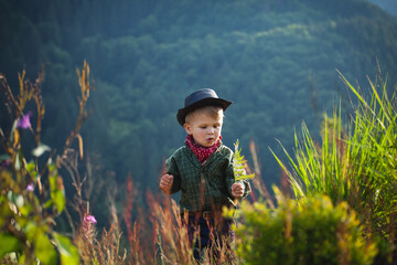 Cute Little Boy with Hat and Bandana in Beautiful Mountains - 743835239