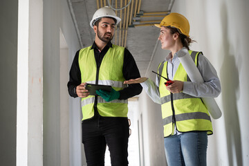 Middle east  engineer man and woman working with tablet computer and paper work in building at...