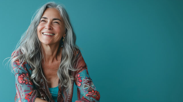  A studio portrait capturing the joyful essence of a woman with grey hair against a turquoise backdrop, embodying a blend of Mexican and American cultures with a chic, post-'70s vibe 