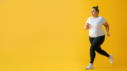 Fototapeta na wymiar A stylish woman exudes confidence in her white shirt and black leggings, showcasing her active lifestyle as she stands against a yellow wall, ready to dance with her flexible and toned body