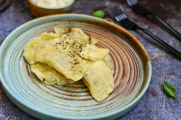 Home made italian ravioli filled with   meat and parmesan cheese   on wooden background.Organic  egg  fresh  pasta .