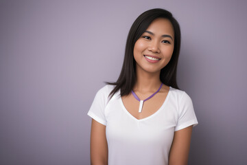 Fototapeta premium portrait of an Indonesian woman wearing white tees, black long hair simple friendly smile
