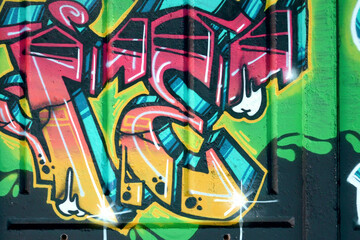 Colorful background of graffiti painting artwork with bright aerosol outlines on wall. Old school...