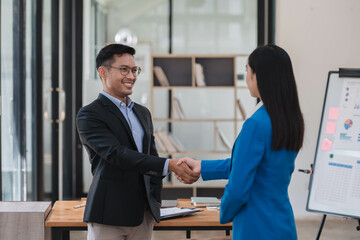 Professional business people having a handshake, completing a big deal.