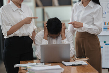 Frustrated Asian employee feels stressed suffers from hostile coworkers.
