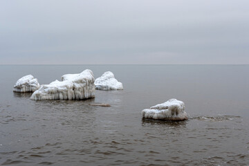 Seascape depicting landscape of Baltic sea and beach with ice and snow formations