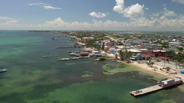 Aerial drone view of San Pedro, Ambegris Caye in Belize. Flying over tropical Caribbean island. Boats and docks.