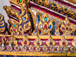 Thailand, Bangkok traditional wood carving and ornament with colorful glasses and gold color