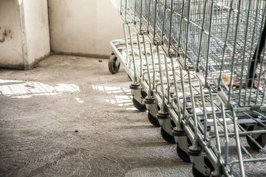 Close up of side and wheels of shopping trolleys in a line