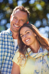Fototapeta premium Portrait, love and couple with smile in park for summer romance, trees and fun outdoor date. Relax, mature man and happy woman in garden with morning sunshine, hug and marriage bonding in nature.