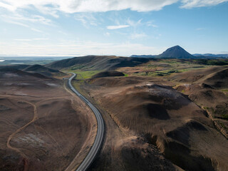 Panorama view of Ring Road in Iceland and scenic landscape of volcano rock formations on a bright summer day, aerial shot. Travel destination concept.
