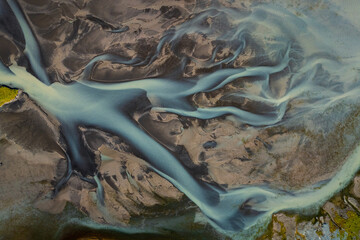 Abstraction of patterns and colors of Icelandic rivers, a mix of glacial melt water, silt, and...