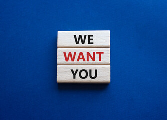 We want you symbol. Concept words We want you on wooden blocks. Beautiful deep blue background. Business and We want you concept. Copy space.