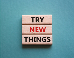 Try new Things symbol. Concept words Try new Things on wooden blocks. Beautiful grey green...
