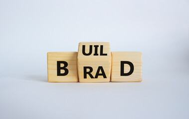 Build your brand symbol. Wooden cubes with words Build and Brand. Beautiful white background. Build...