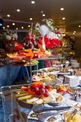 Assorted fruits and snacks on a stylish buffet table at an elegant event.