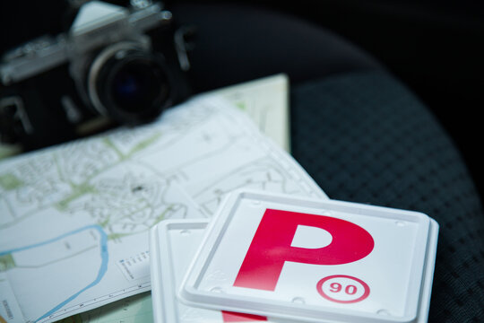 Red P plates and map on back seat of car