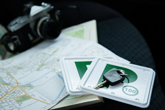 Green p plates, camera and map pn car backseat