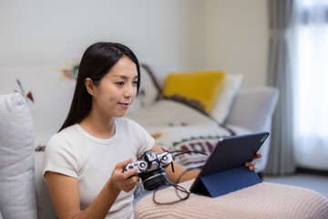 Woman use digital camera connect with tablet computer at home