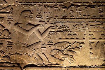 Close up of ancient egyptian wall relief carving with hieroglyphs inside Luxor temple, Egypt - 743898445