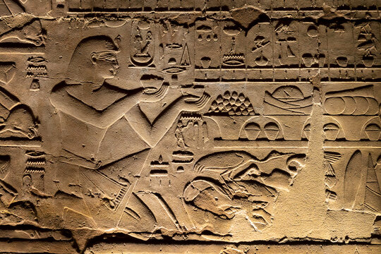 Close up of ancient egyptian wall relief carving with hieroglyphs inside Luxor temple, Egypt