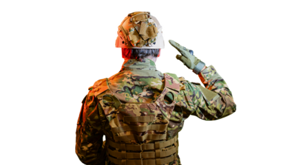 An American soldier salutes in a dramatic light