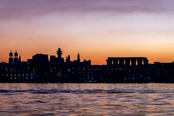 Silhouette of Luxor temple, view of the Nile river East bank at sunrise in Luxor, Egypt - obrazy, fototapety, plakaty