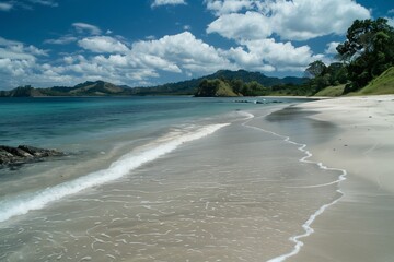 A pristine beach stretches as far as the eye can see, its powdery sand kissed by the gentle caress of the tide.