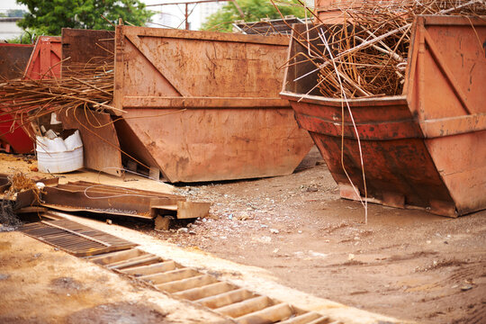 Recycle, scrap and rust on skip in junkyard for sorting, garbage and metal reuse at landfill site. Steel, iron and industrial bin for truck transport with urban pollution at waste dump with machine