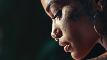 Close up portrait of beautiful african american young woman with a tattooed face with earrings and piercing