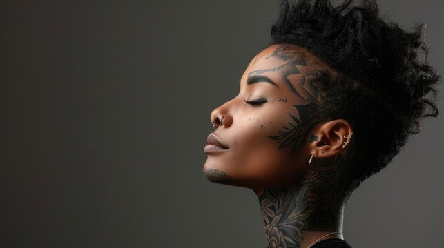 Close up portrait of beautiful african american young woman with a tattooed face with earrings and piercing