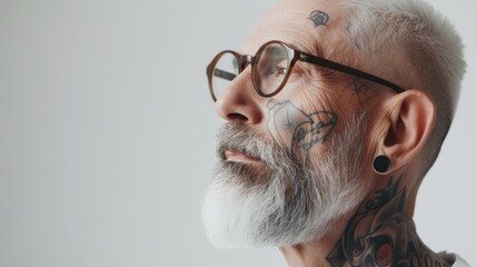 Senior silver-haired man showcasing his extensive tattoos, each a chapter of life etched into his skin, exuding a narrative of experiences and resilience. Elderly stylish aged model - obrazy, fototapety, plakaty