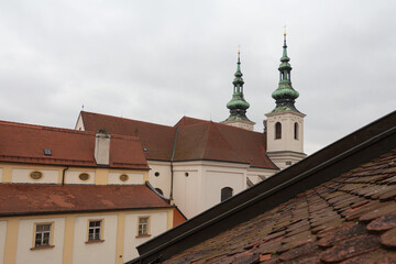 View of the roofs and the Church of St. Michael on a cloudy morning. Czech Republic