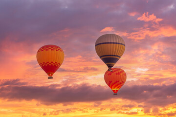 Close up of coloful hot air balloons, scenic pink sky at sunrise