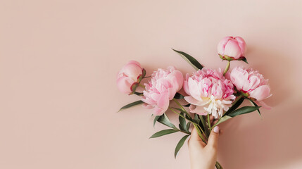 Elegant pink peonies bouquet with copy space on a pastel background, perfect for Mother's Day or spring-themed designs